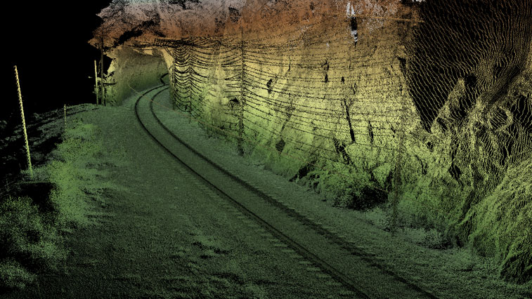 A 3D scan of a railway track curving through a rocky tunnel with mesh and terrain details